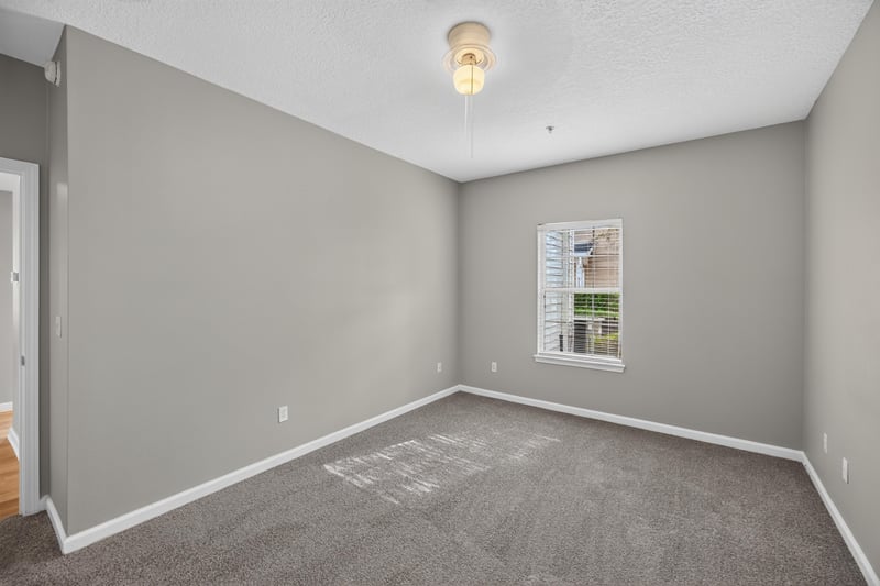 Bedroom with window and carpet at 575 Oakleaf Plantation Pkwy, Orange Park, FL 32065