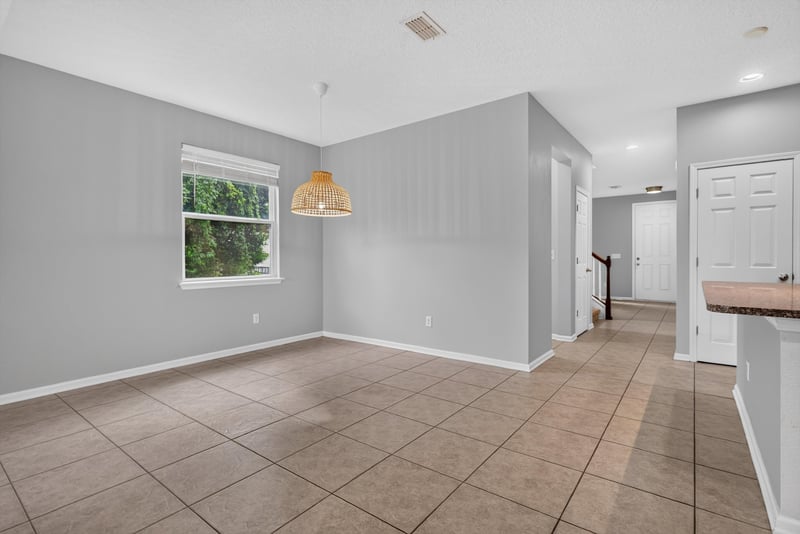 Dining area with pendant light and pass-through to kitchen at 13685 Goodson Pl, Jacksonville, FL 32226