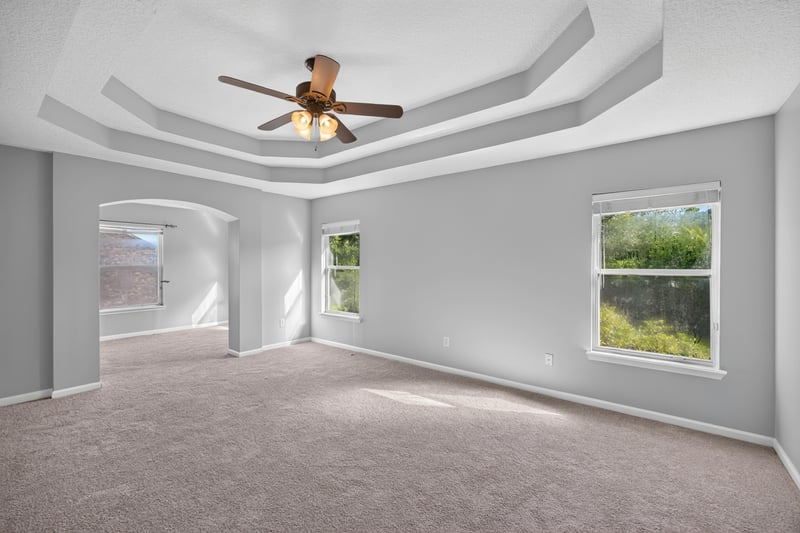 Primary bedroom with tray ceiling and carpet at 470 Sparrow Branch Cir, Jacksonville, FL 32259