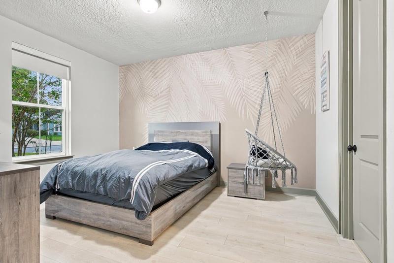 Bedroom with bunk beds and herringbone accent wall at 3921 Spyglass Hill Ln