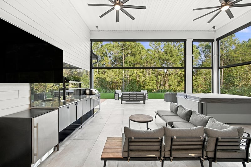 Covered patio with outdoor kitchen and seating area at 907 Seagrove Dr, Ponte Vedra Beach, FL 32081