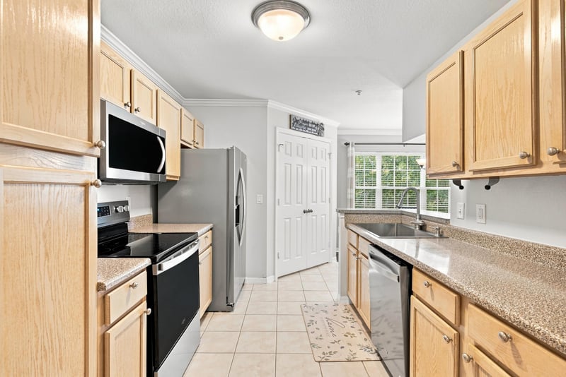 Kitchen with oak cabinets and stainless appliances at 7800 Point Meadows Dr, Jacksonville, FL 32256
