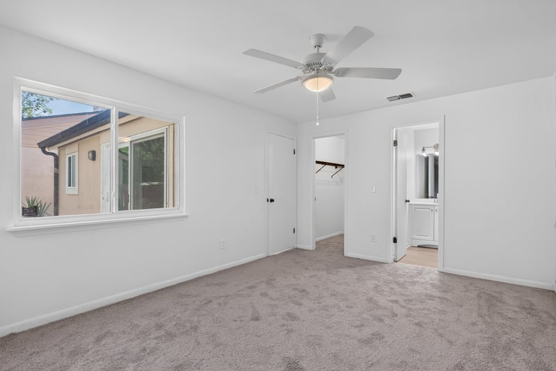 Carpeted room with window and multiple doors at 8177 Virgo St, Jacksonville, FL 32216