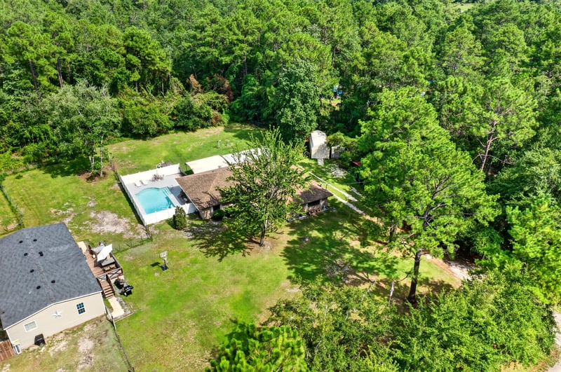 Aerial view of the home with pool and detached structure at 2435 Range Line Rd, Middleburg, FL
