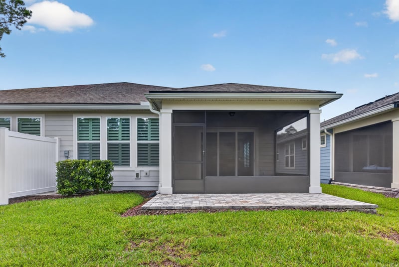 Rear exterior with screened porch and open lawn at 171 Oyster Shell Ter, Nocatee, FL 32081