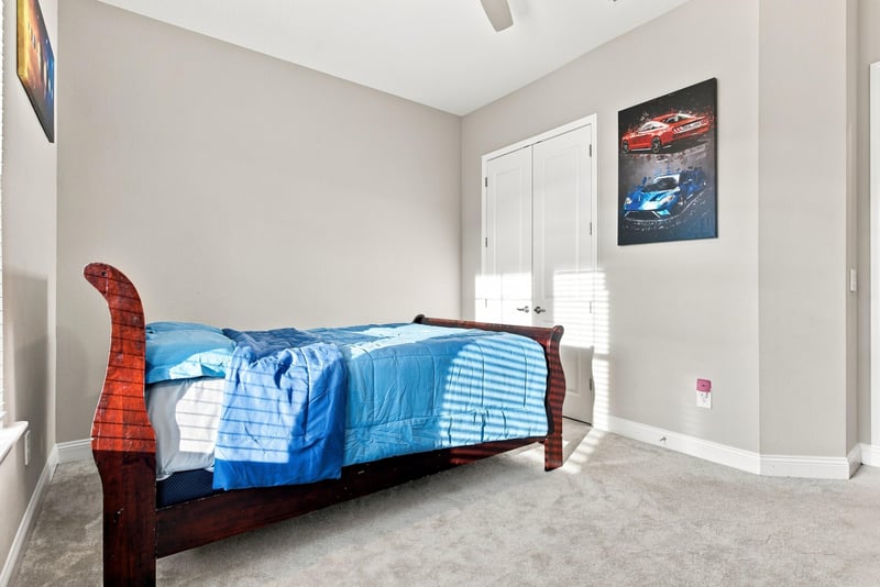 Secondary bedroom with sleigh bed and carpet flooring at 27 Holly Rdg Wy, St. Augustine, FL