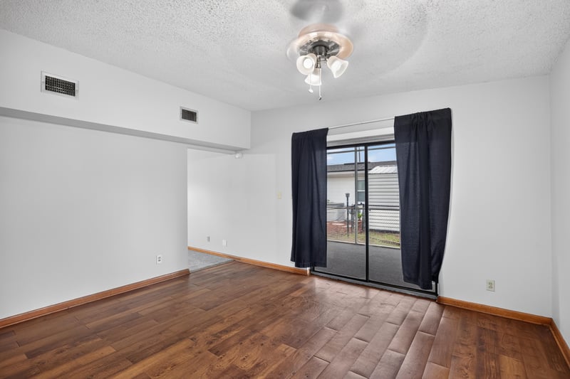 Dining room with wood floor leading to patio door at 11462 Elane Dr, Jacksonville, FL