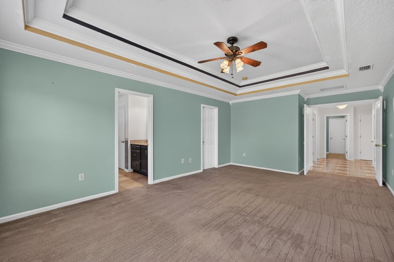 Empty primary bedroom with closet doors at 2282 Justin Lake Dr, Jacksonville, FL