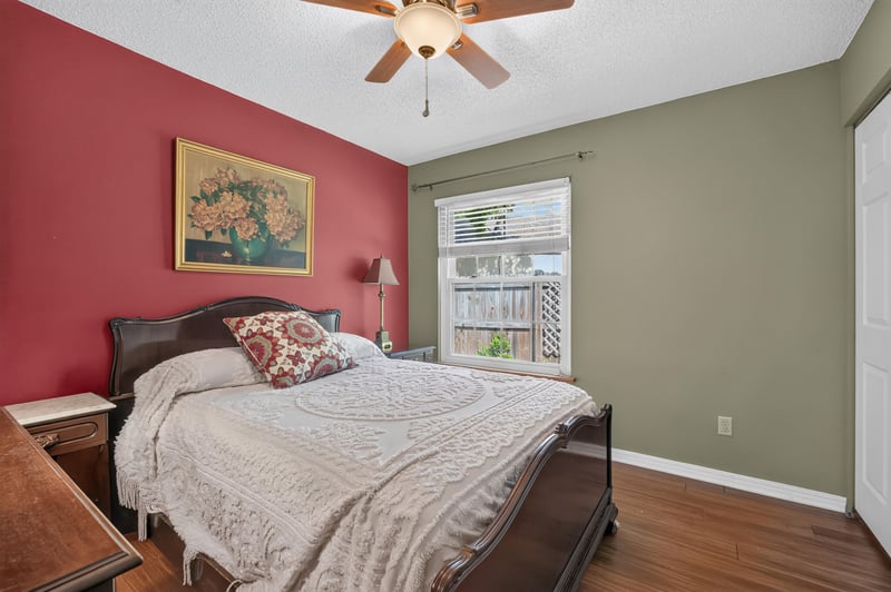 Bedroom with red walls and wood bed frame at 4837 Pareja Ct, Jacksonville, FL 32225