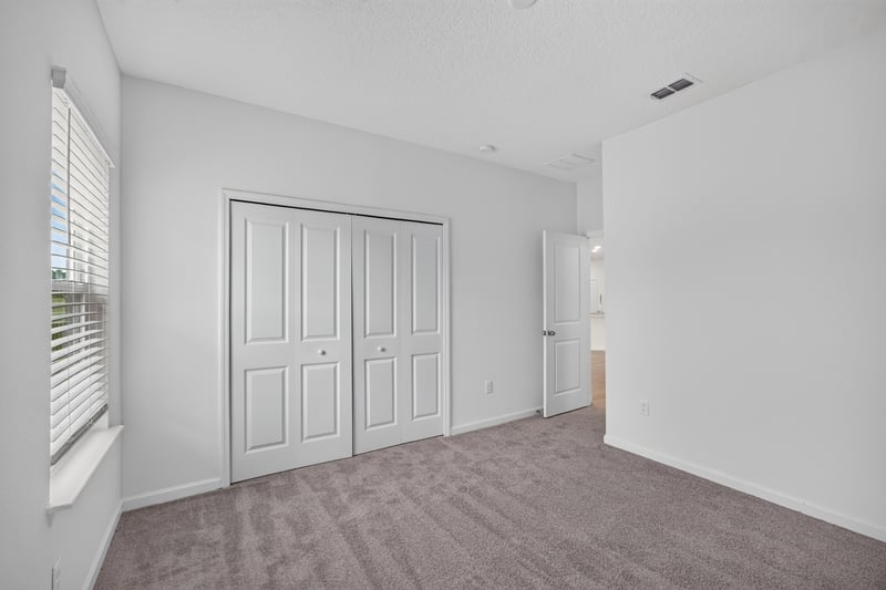 Bedroom with closet and carpet flooring at 9905 Ansley Lake Dr, Jacksonville, FL