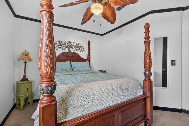 Bedroom with four-poster bed at 6931 Cane Grass Ln E, Jacksonville, FL 32244