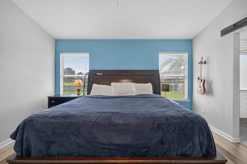 Primary bedroom with windows and ceiling fan at 2065 Creekmont Dr