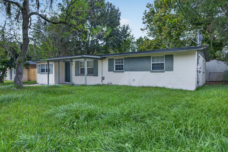 Front elevation with green shutters and lawn at 5812 Tampico Rd, Jacksonville, FL 32244