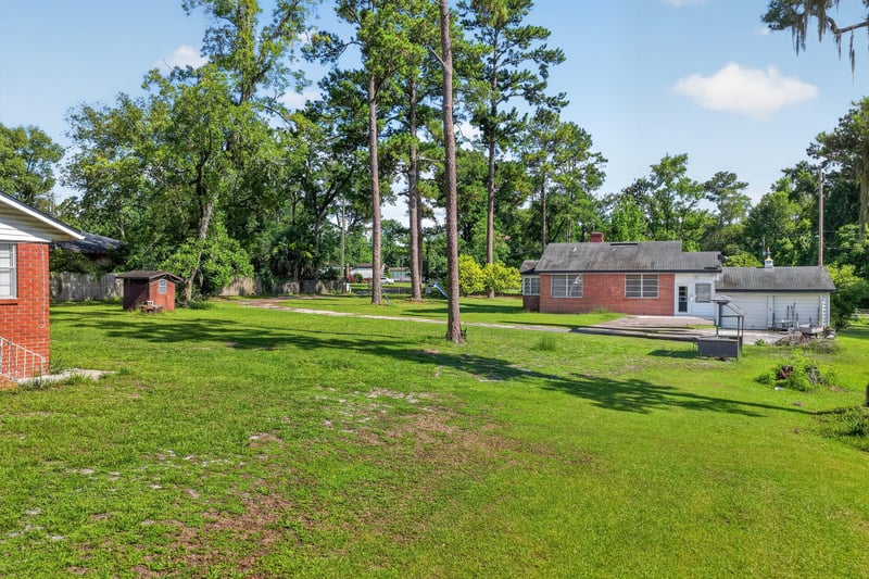 Backyard lawn with shed and trees at 5745 110th St, Jacksonville, FL 32244