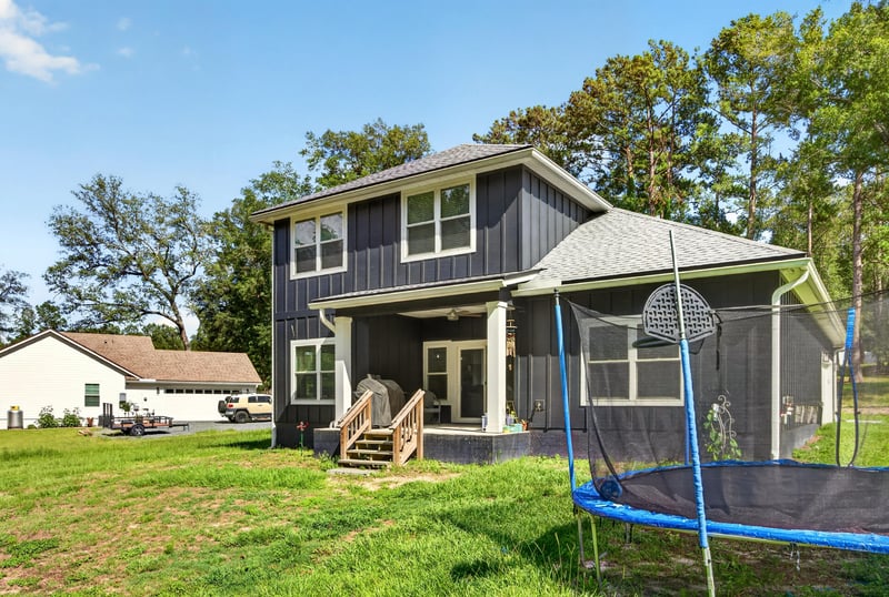 Aerial view of the backyard with trampoline and screened porch at 2817 Camel Cir, Middleburg, FL