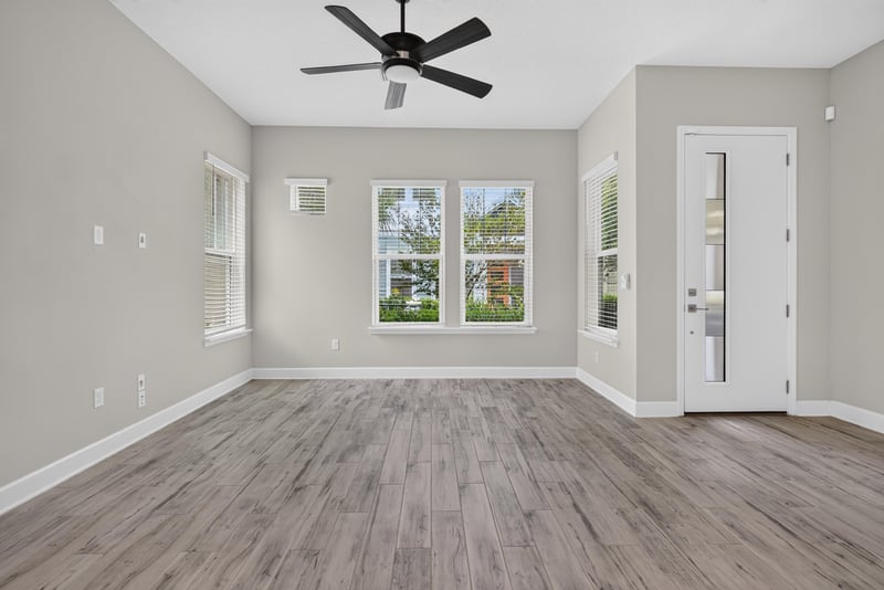 Living room with ceiling fan and windows at 7446 Loggerhead Ct, Jacksonville, FL 32256