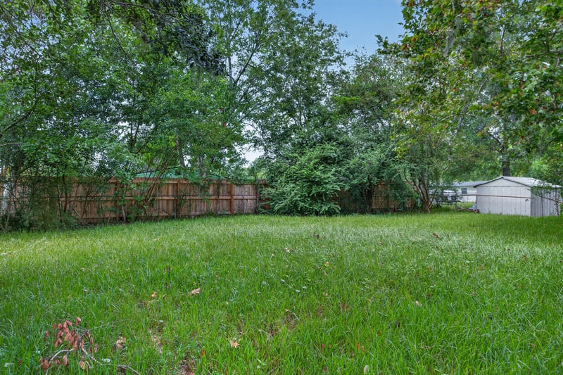 Backyard lawn with fence and trees at 5812 Tampico Rd, Jacksonville, FL 32244
