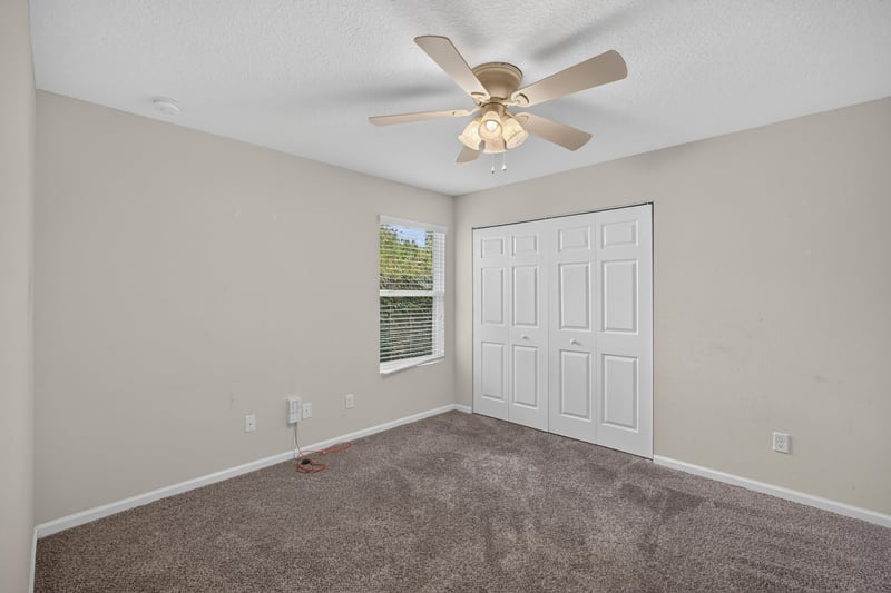 Empty bedroom with carpet and closet doors at 1002 Ingleside Ave, Jacksonville, FL 32205