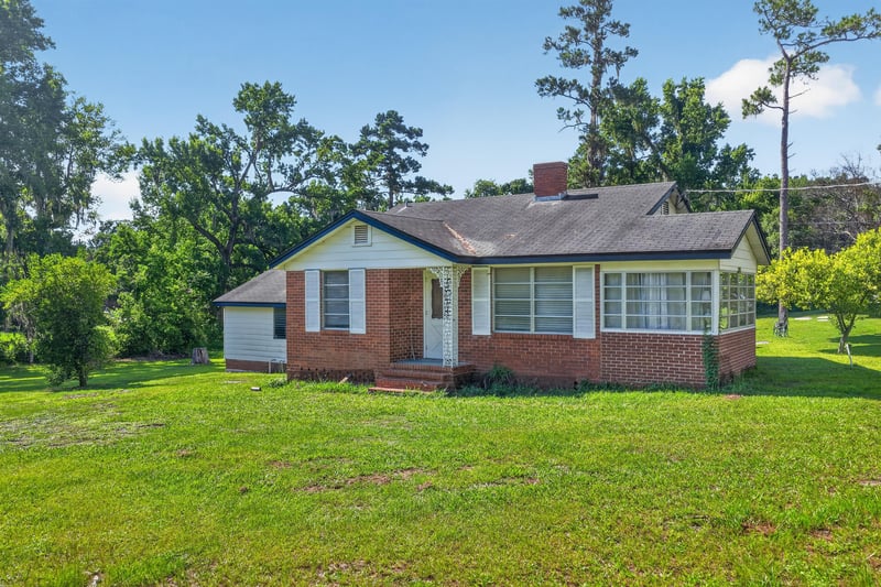 Front exterior view across open lawn at 5745 110th St, Jacksonville, FL 32244