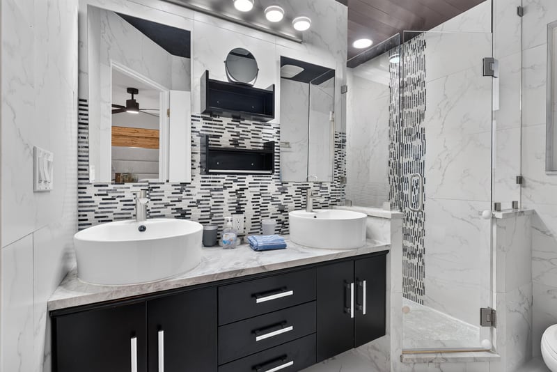 Bathroom with black vanity and mosaic tile accent at 1525 8th St N, Jacksonville Beach, FL