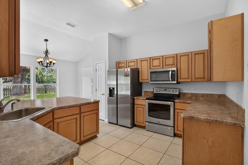 Kitchen with island and tile flooring at 456 Bay Point Way N, Jacksonville, FL 32259