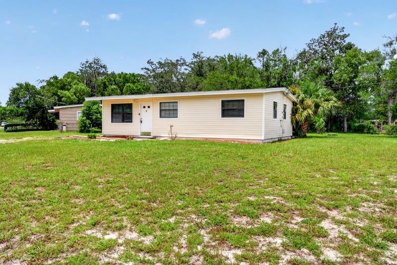 Front exterior from side angle on grassy lot at 255 Woodside Dr, Orange Park, FL 32073