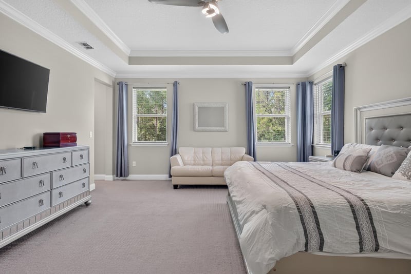 Primary bedroom with seating area at 22 Azura Point