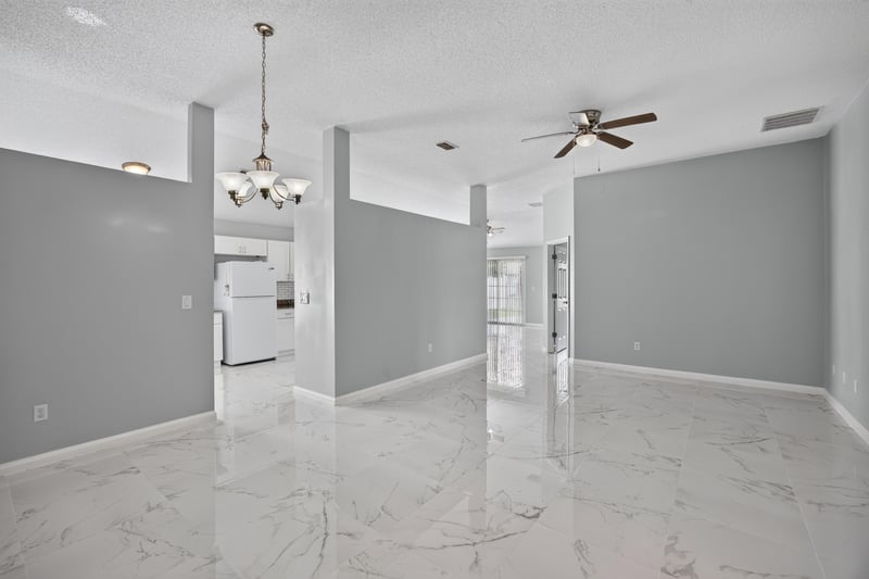 Open living room with ceiling fan and tile flooring at 490 Hillside Dr, Orange Park, FL 32073