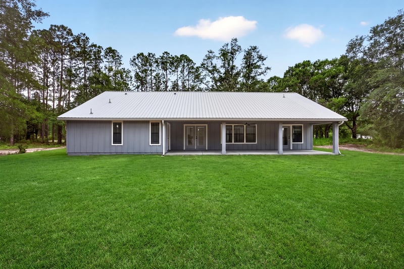 Side exterior yard, unfurnished lawn at 4800 Acacia St, Middleburg, FL 32068