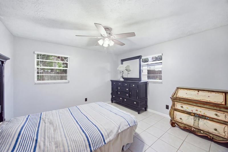 Bedroom with striped bedding and dresser at 417 Capricorn Ln, Orange Park, FL 32073