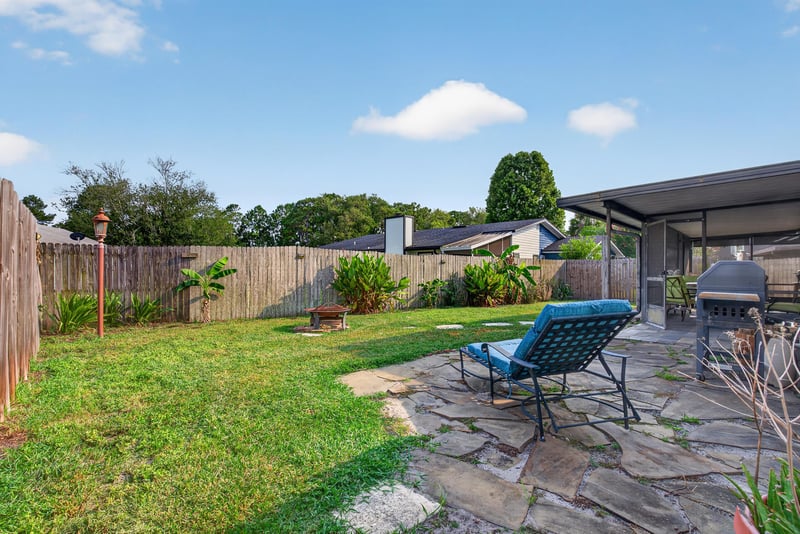 Backyard with patio furniture and fenced yard at 13020 Medford Ln, Jacksonville, FL 32225