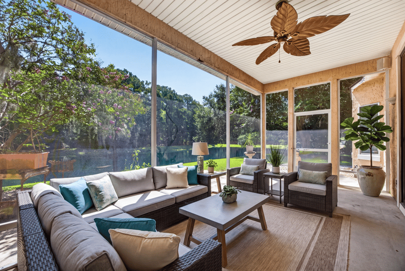 Screened porch furnished with seating and pond view at 11675 Magnolia Estates Rd, Jacksonville, FL 32223