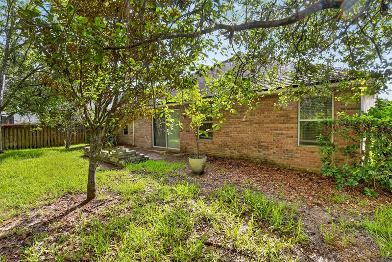 Backyard view with tree and brick exterior at 299 John's Creek Pkwy, St. Augustine, FL 32092