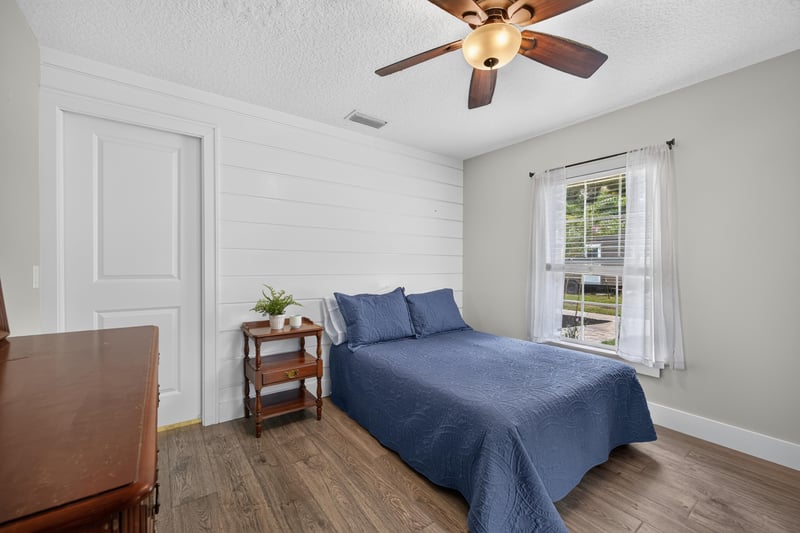 Bedroom with blue bedding and window at 1161 Whispering Pines Rd, Jacksonville, FL 32259