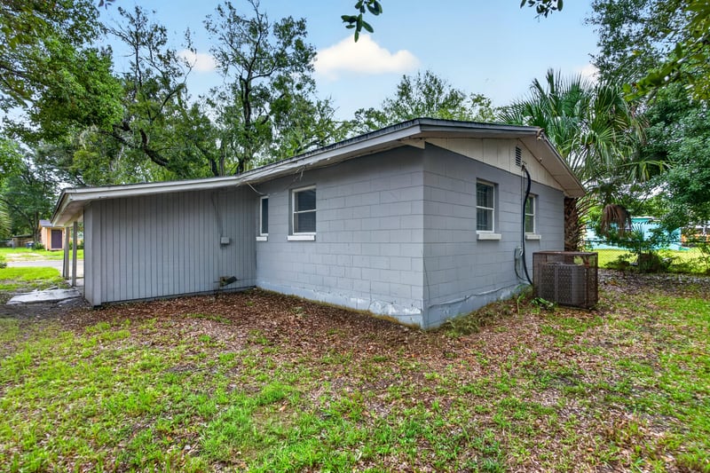 Rear exterior with AC unit and palm tree at 4030 Leonard Cir W, Jacksonville, FL 32209