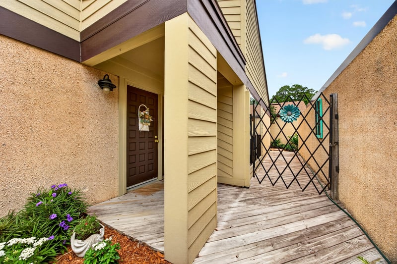 Gated courtyard entry with front door at 3407 Fairbanks Grant Rd N, Jacksonville, FL 32223