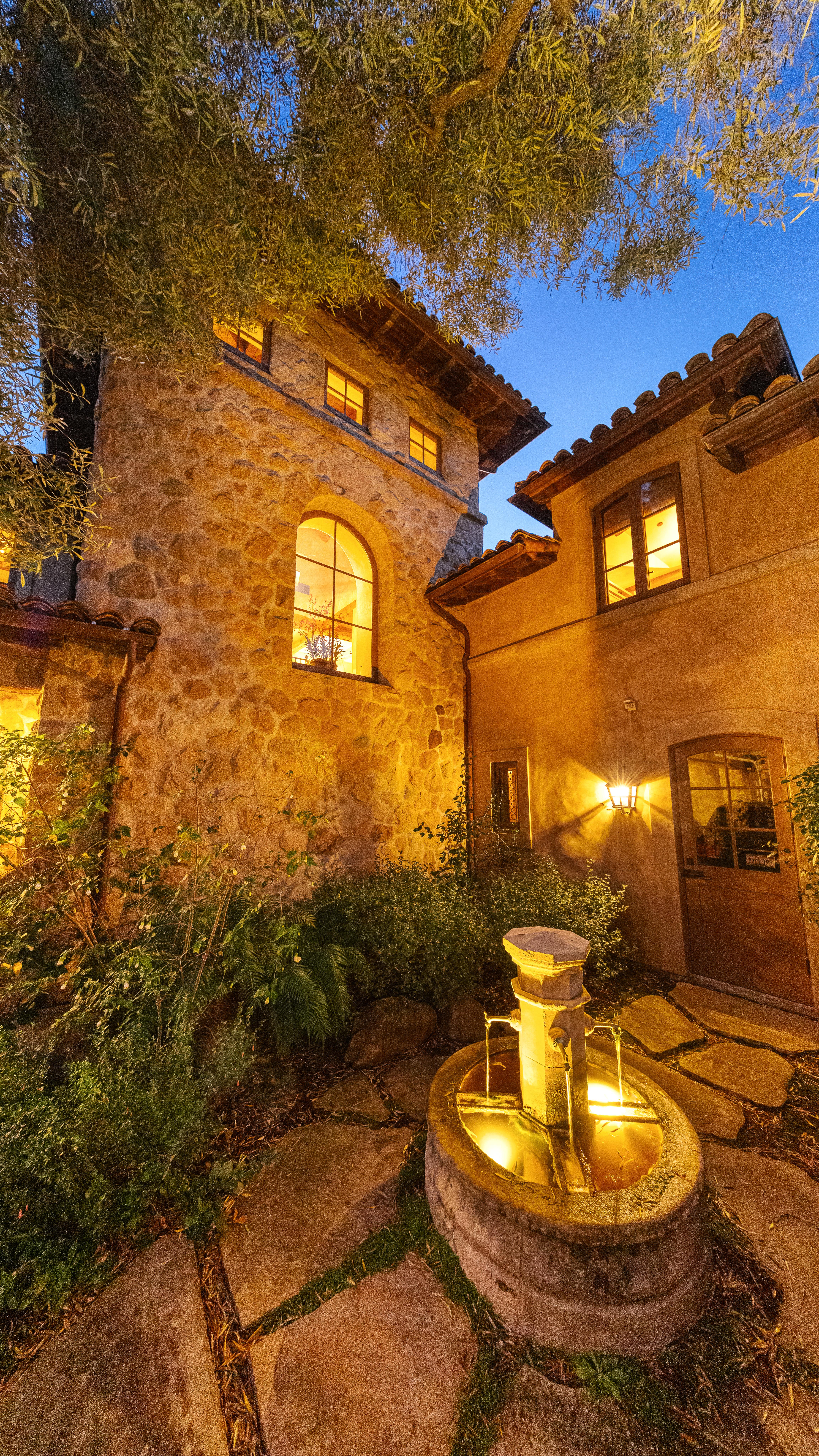 Twilight photography of the illuminated facade at 1915 Monte Alegre Dr, Carpinteria — golden-hour light dissolves into coastal dusk along the American Riviera's most coveted southern corridor. Our team captured editorial photography, aerial drone photography via Inspire 3 Cinema Drone, a cinematic property video, a true vertical social media reel, and twilight photography from midday through twilight.