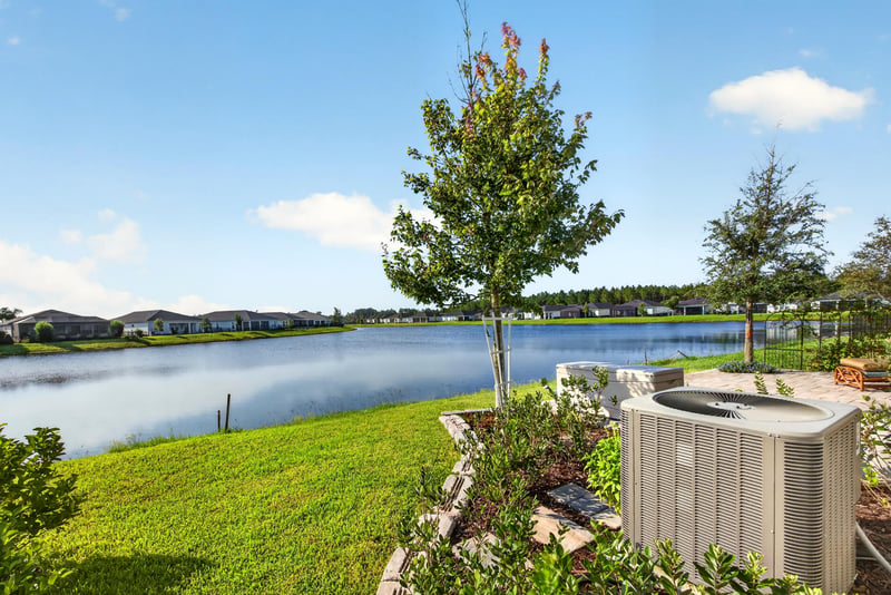 Aerial view of the backyard with AC unit and pond at 129 Amberwood Dr, St. Augustine, FL