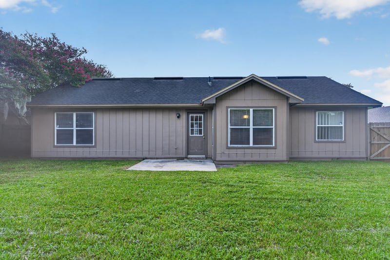 Rear exterior with patio and grass yard at 6646 Shiloh Creek Dr