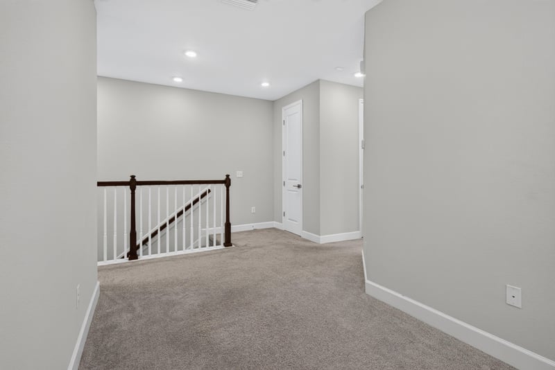 Upstairs hallway with staircase railing at 7446 Loggerhead Ct, Jacksonville, FL 32256