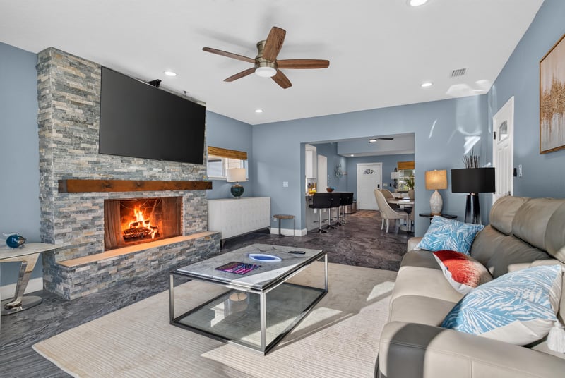 Living room with fireplace opening to kitchen at 1525 8th St N, Jacksonville Beach, FL