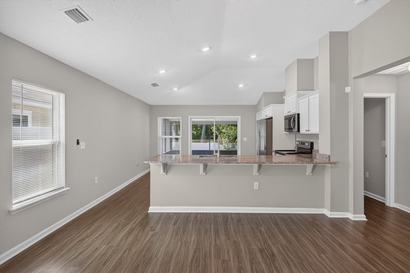 Living room open to kitchen at 7118 Preston Pnes Trl, Jacksonville, FL