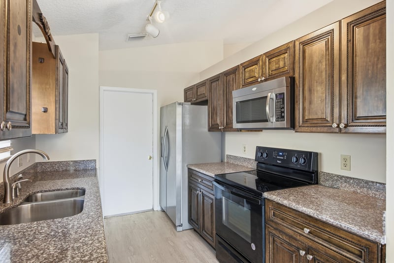 Kitchen with wood cabinets and appliances at 678 5th Ave N, Jacksonville Beach, FL 32250