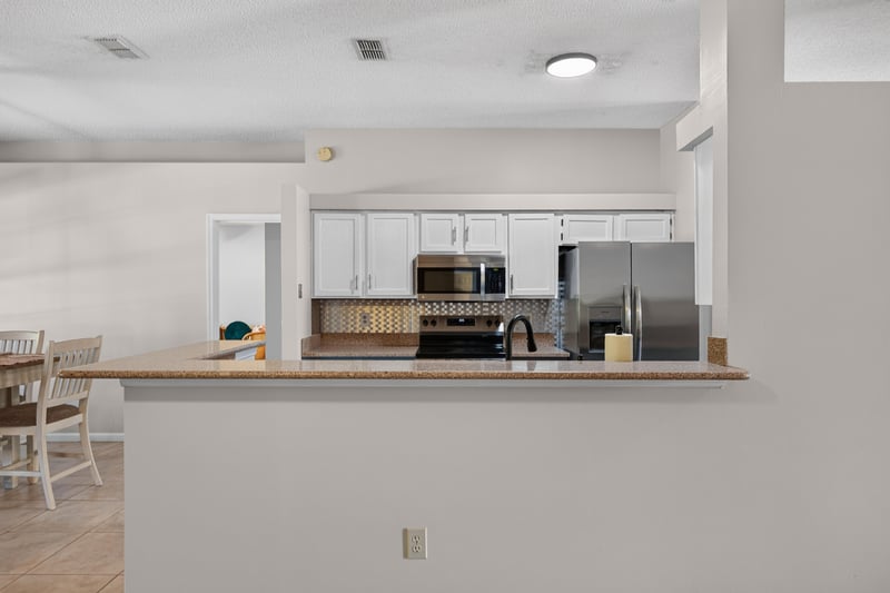 Kitchen with white cabinets and microwave at 11828 Heather Grove Ln, Jacksonville, FL