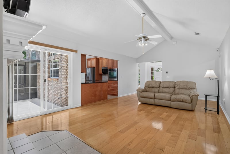 Kitchen opening to family room with wood floors at 12810 Swamp Owl Ln