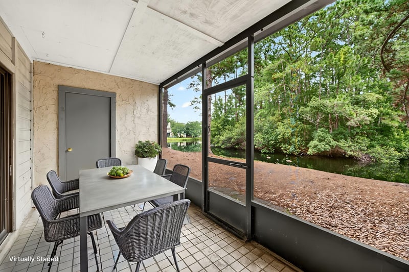 Screened porch with table and chairs, virtually staged, at 3801 Crown Point Rd unit 2061, Jacksonville, FL 32257