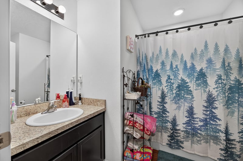 Second bathroom vanity with mirror and sink at 518 Matecumbe Ct, Macclenny, FL