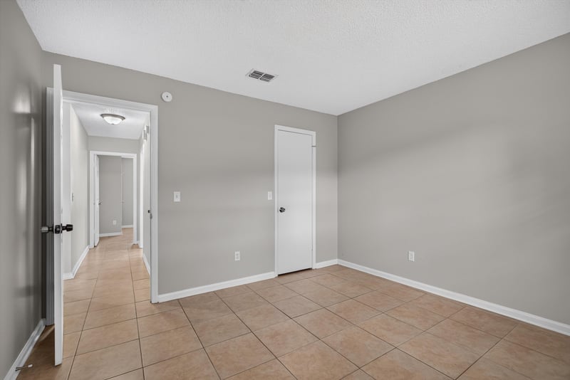 Hallway with closet doors and tile floor at 1040 Willow Cove Ct E, Jacksonville, FL 32233