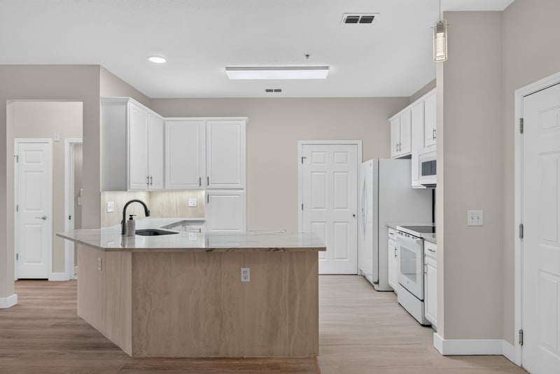 Kitchen view toward island and laundry door at 11251 Campfield Dr unit 1202, Jacksonville, FL 32256