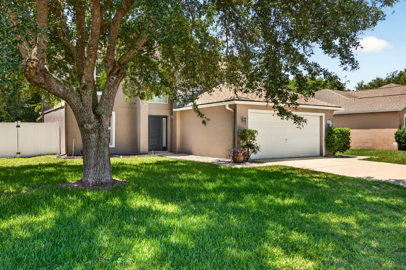 Front exterior shaded by oak tree at 3428 Glenn Hollow Ct, Jacksonville, FL 32226